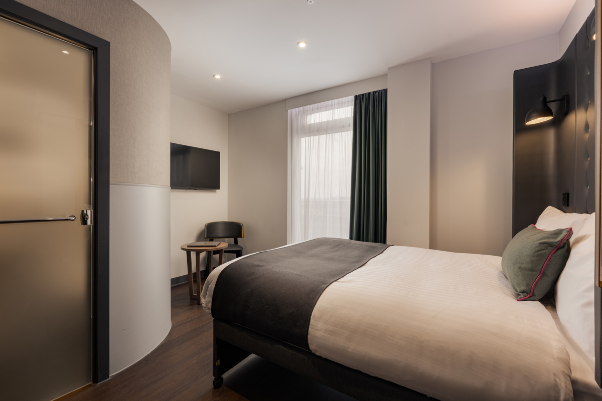 Modern double room with a neatly made bed, clean white linens, and minimalist décor at Point A Hotel St Andrews Square, Edinburgh