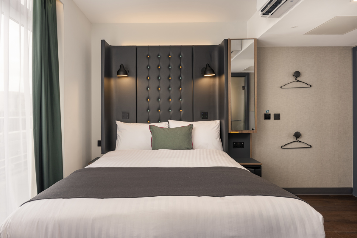 Modern double room with a neatly made bed, clean white linens, and minimalist décor at Point A Hotel St Andrews Square, Edinburgh